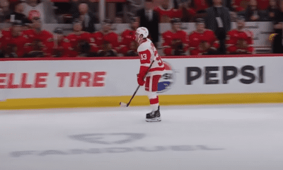 Alex DeBrincat #93, of the Detroit Red Wings scores with 1.5 seconds in the first period against the Chicago Blackhawks